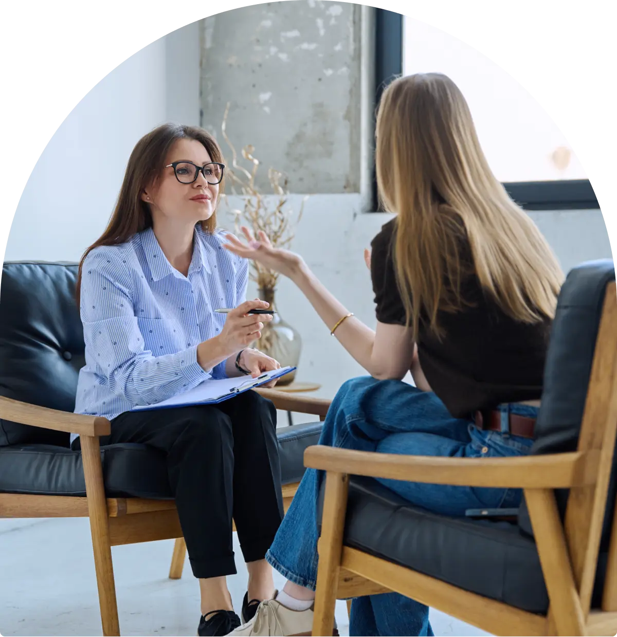 Two women having a conversation indoors.