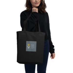 Woman holding a black tote bag.